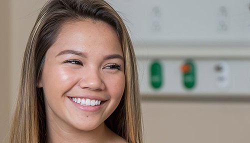Teen girl smiling in doctor's office.