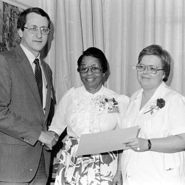 Carol Ball, Ruth Brooks and Ron Peterson at a ceremony
