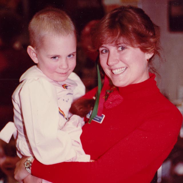 A nurse holds a young girl.