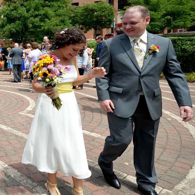 Photo shows Hopkins Bayview financial manager Nicole Utech walking the abyrinth path with her husband after exchanging wedding vows at the site.