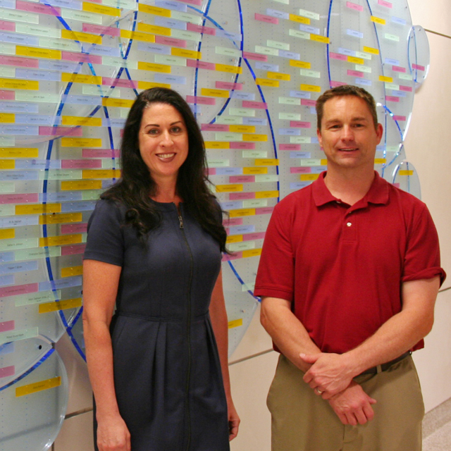Photos shows Brigitte Sullivan and Clint Burns, who worked with the wall’s design team, which included Jim Lustek, director of brand management; Michael Iati, senior director of architecture and planning for the health system; Jennifer Fairman, assistant professor of art as applied to medicine; a donor family member; and Andrew Petitti, the designer.