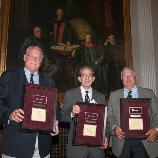 Stephen Achuff, Charles Angell and Craig Smith display their Osler Latchkey Awards. The key is a duplicate of the only surviving latchkey provided by William Osler to several of his junior housestaff so they could have access to his extensive home library.