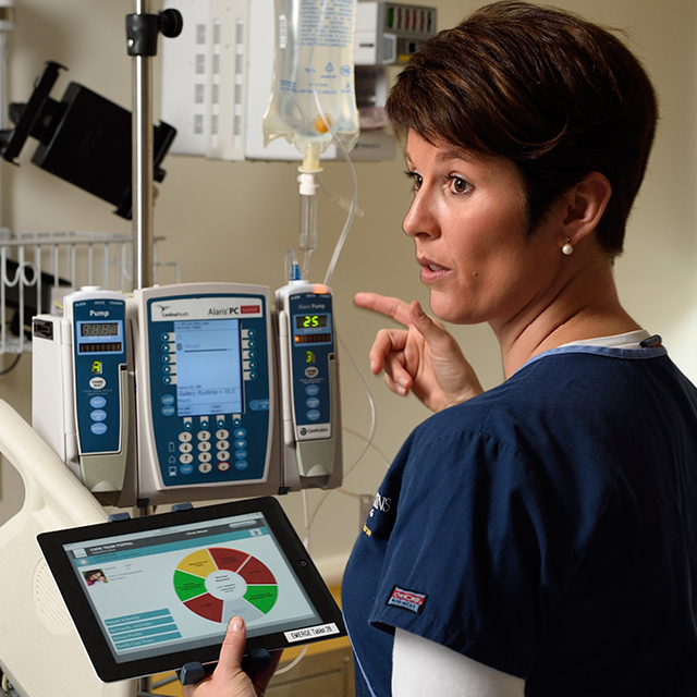 A photo of Rhonda Wyskiel carrying a tablet computer.