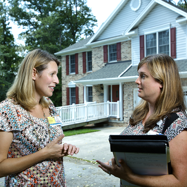 The photo shows Quincy Samus speaking to Kelly Marshall.