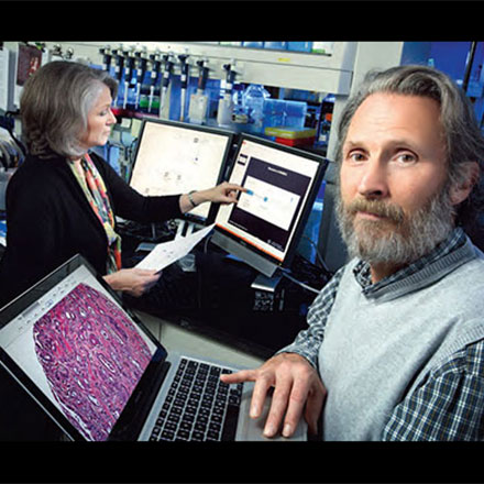 Drs. Williams Isaacs and Kathy Wiley working in a lab.