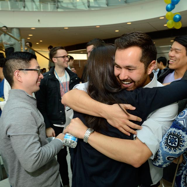 A photo shows people embracing at Match Day. 
