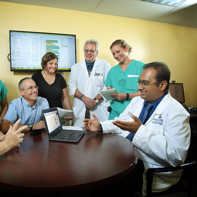 A photo shows the team that created the ReHAP system.