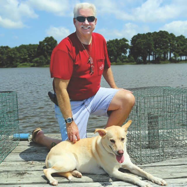 Tom Holste at home with his dog, L.J.