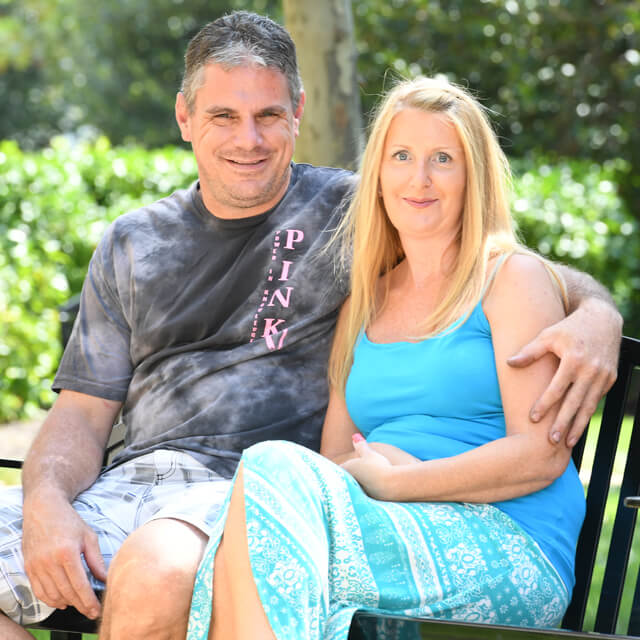Sue Burrs sitting with her husband