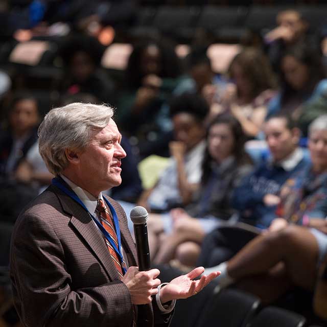 Photo of Dan Ford, vice dean of clinical investigation, talking to students from the stage of the Turner Auditorium during the Henrietta Lacks High School Day.