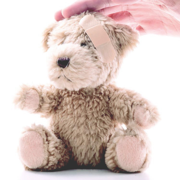 Teddy bear with a band-aid on its forehead