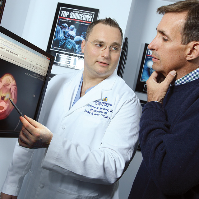 An image shows Wotjek Mydlarz speaking with patient Matt Harcourt.