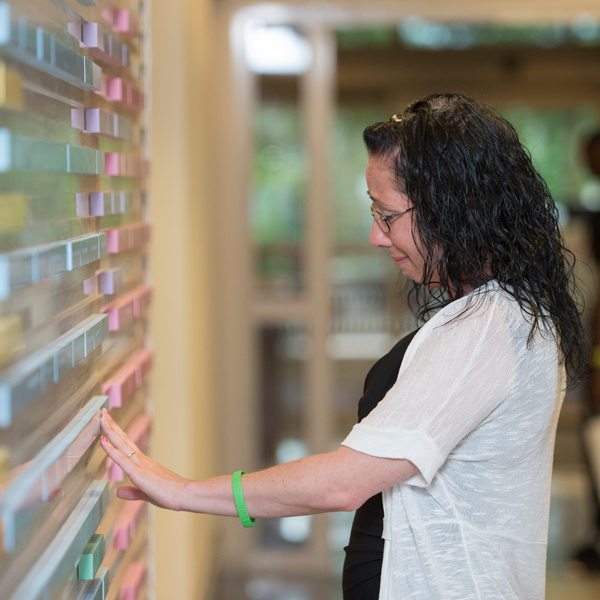 Brenda Ryan touching her brother's name on the organ donor wall at Johns Hopkins Bayview Medical Center