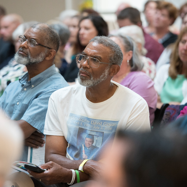 Organ recipients and donors, and their family and friends, listening to stories of lives saved through donation.