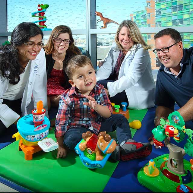 Elliot, his parents, Dr. Courtney Robertson and Dr. Sujatha Kannan