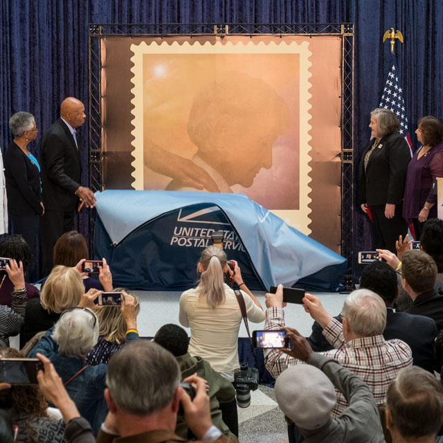 A photo shows the unveiling of the Alzheimer's stamp.