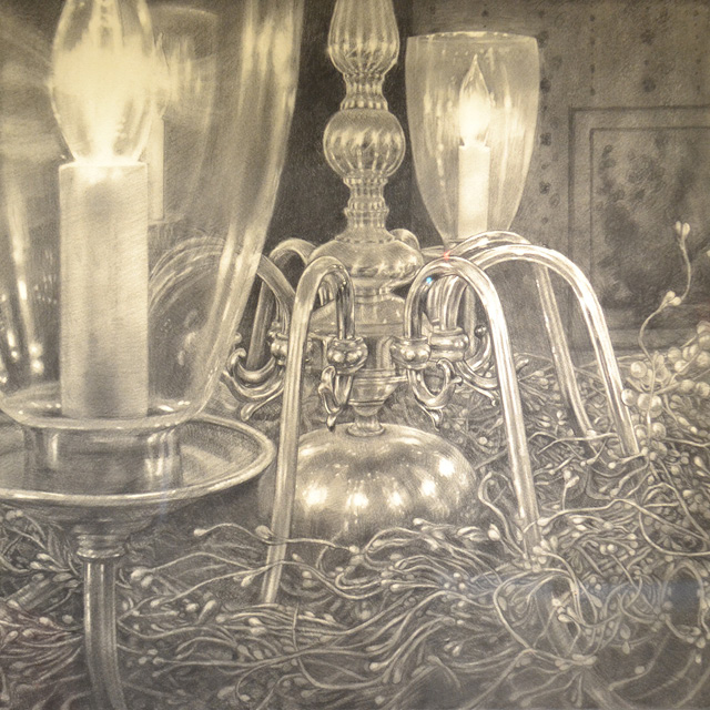 A photo shows a charcoal drawing of a chandelier. 