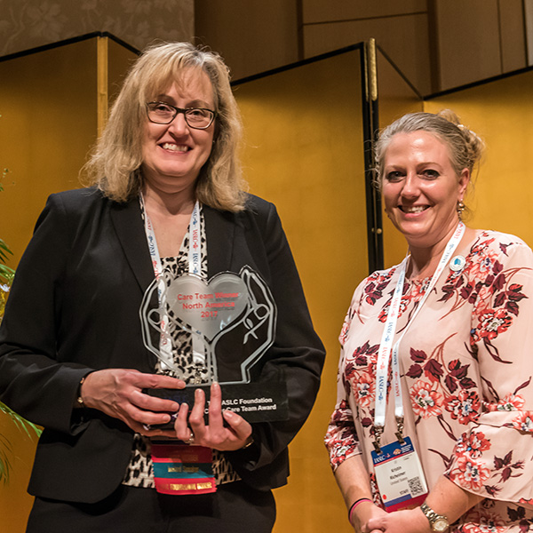 Dr. Julie Brahmer (left) accepts the IASLC Foundation Lung Cancer Care Team Award.