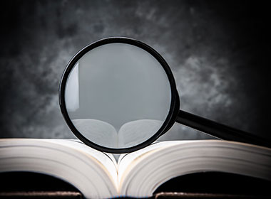 open book with magnifying glass