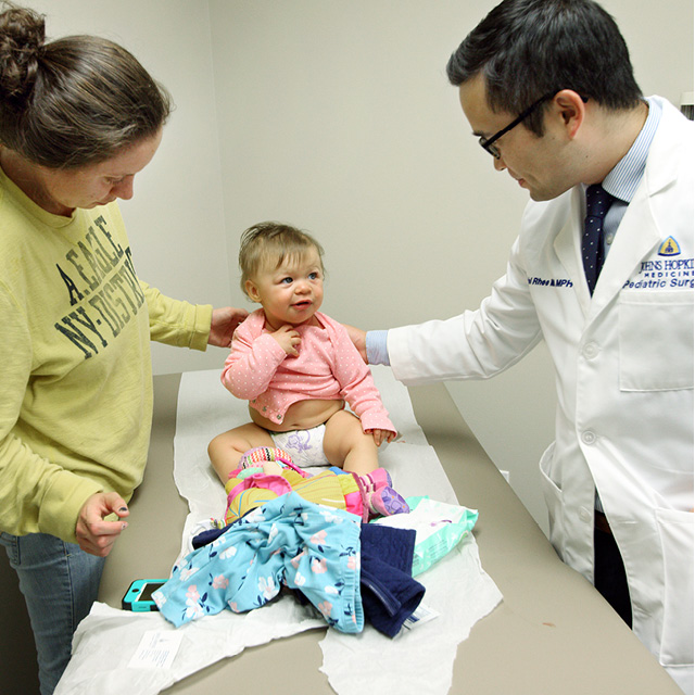 A photo shows Daniel Rhee evaluating a patient after surgery.