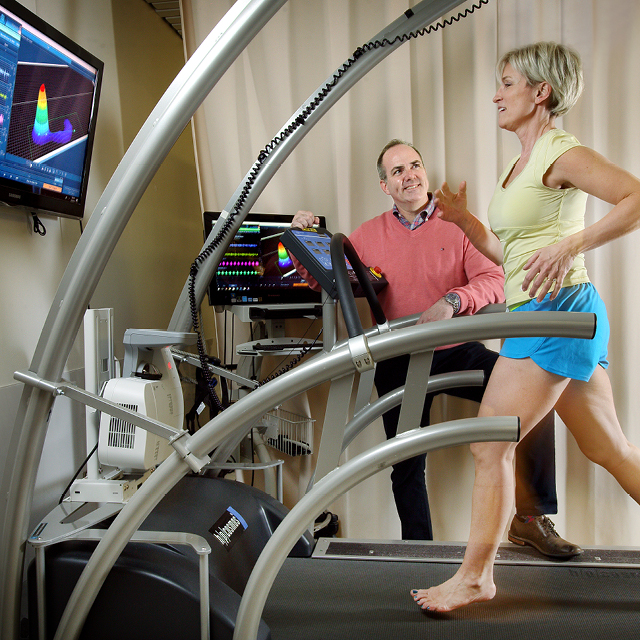 A photo shows Ken Johnson working with a patient on a treadmill in the Running Clinic.