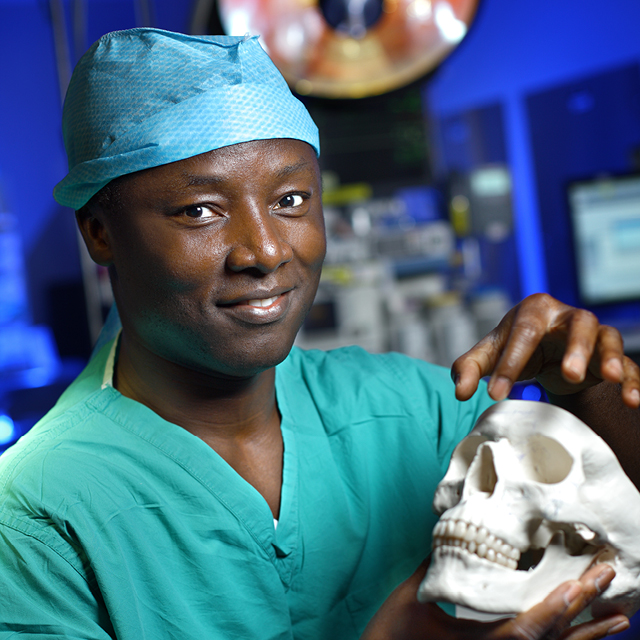Surgeon Kofi Boahene hold model of human skull