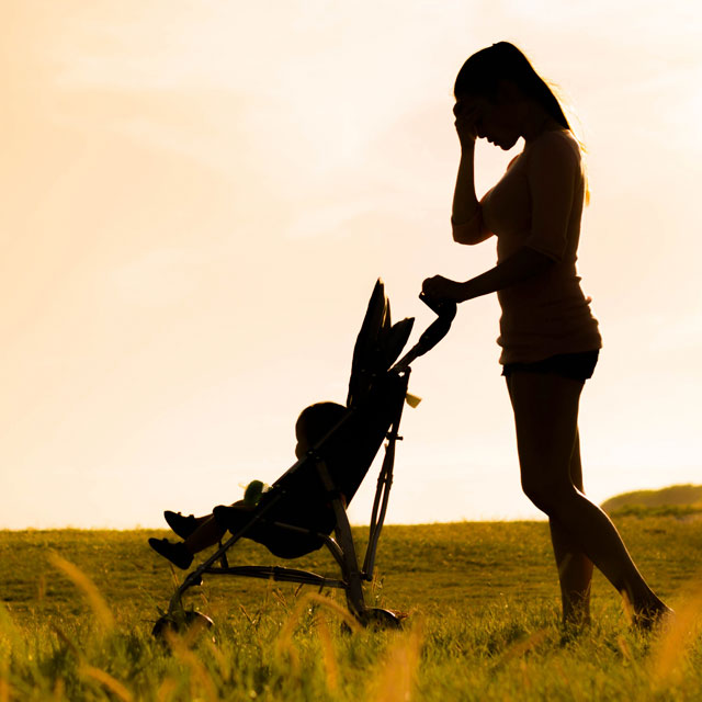 An image shows a woman pushing a baby in a stroller.