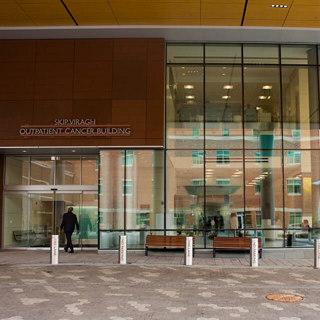 A photo shows the entrance to the Skip Viragh Outpatient Cancer Building. 