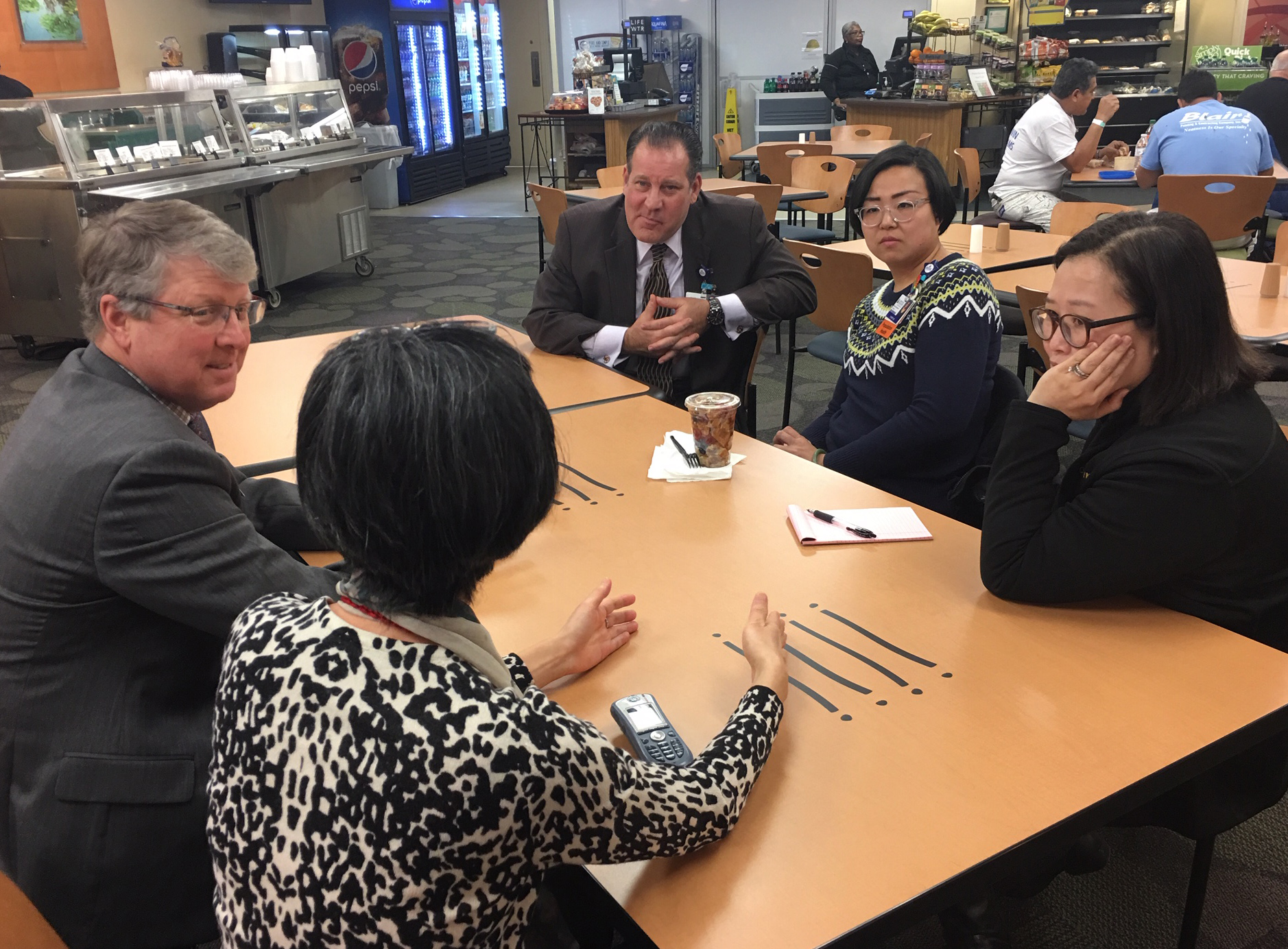 Steve Snelgrove, top left, shares lunch and conversation with hospital employees, clockwise: Jon Oravec, Tammy Liu, Rachel Lee and Bianca Chang.