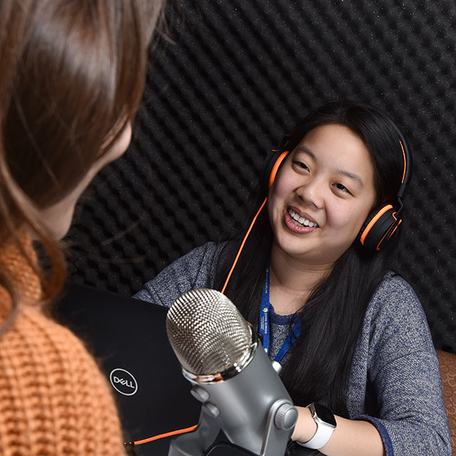 Lilly Su, research program coordinator, talking with a patient