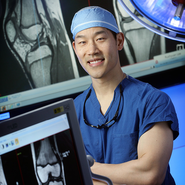 orthopaedic surgeon looking at bone model