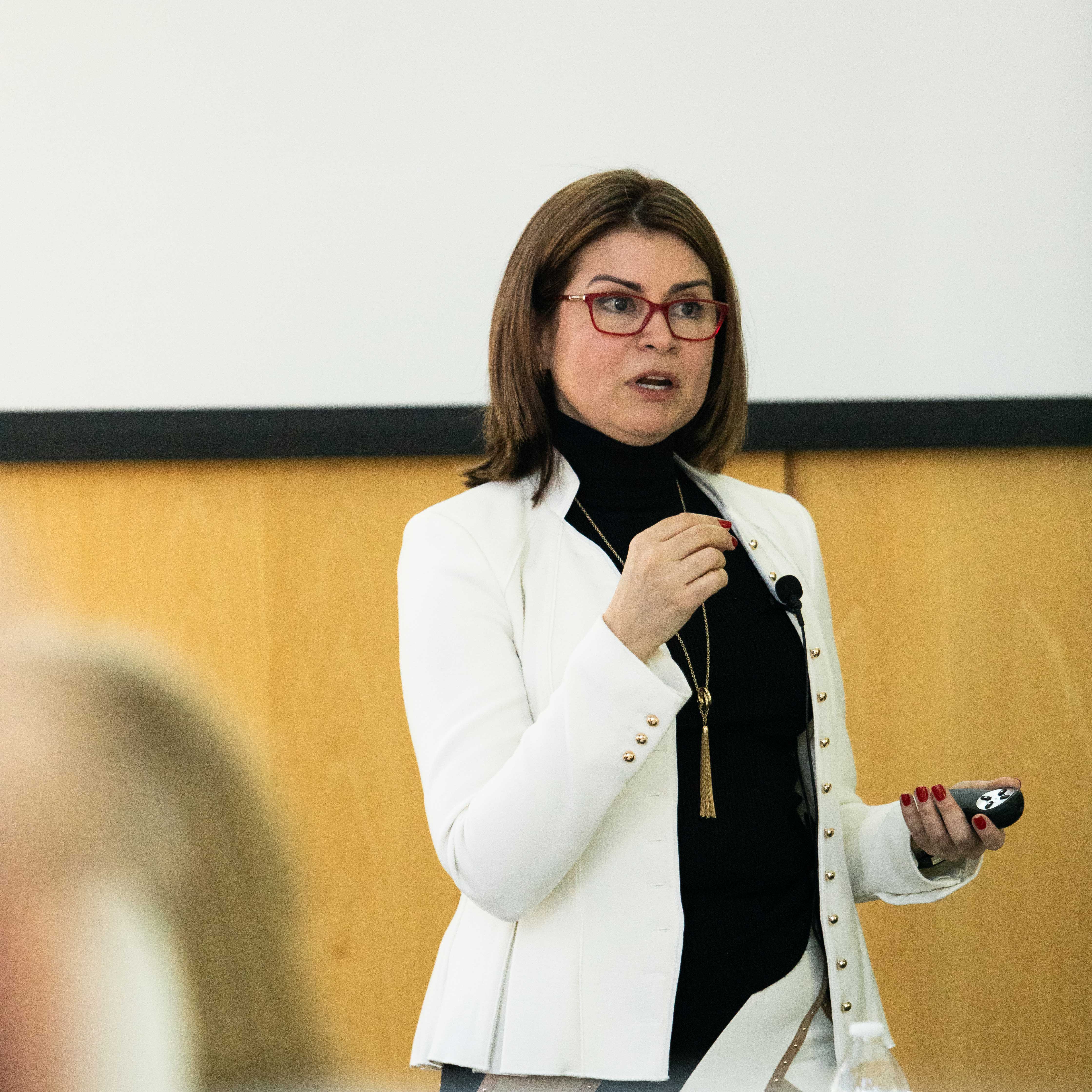 Dr. Zelia Correa speaking during a presentation