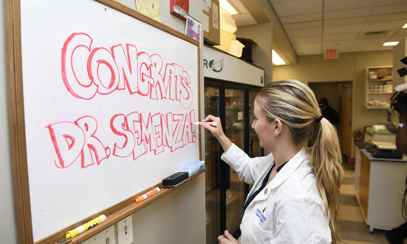 Doctoral student Caroline Vissers writes "congratulations" on the lab team's white board.