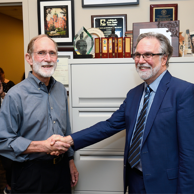 Nobel Laureate Peter Agre, left, congratulates Gregg Semenza on winning the 2019 Nobel Prize in Physiology or Medicine.
