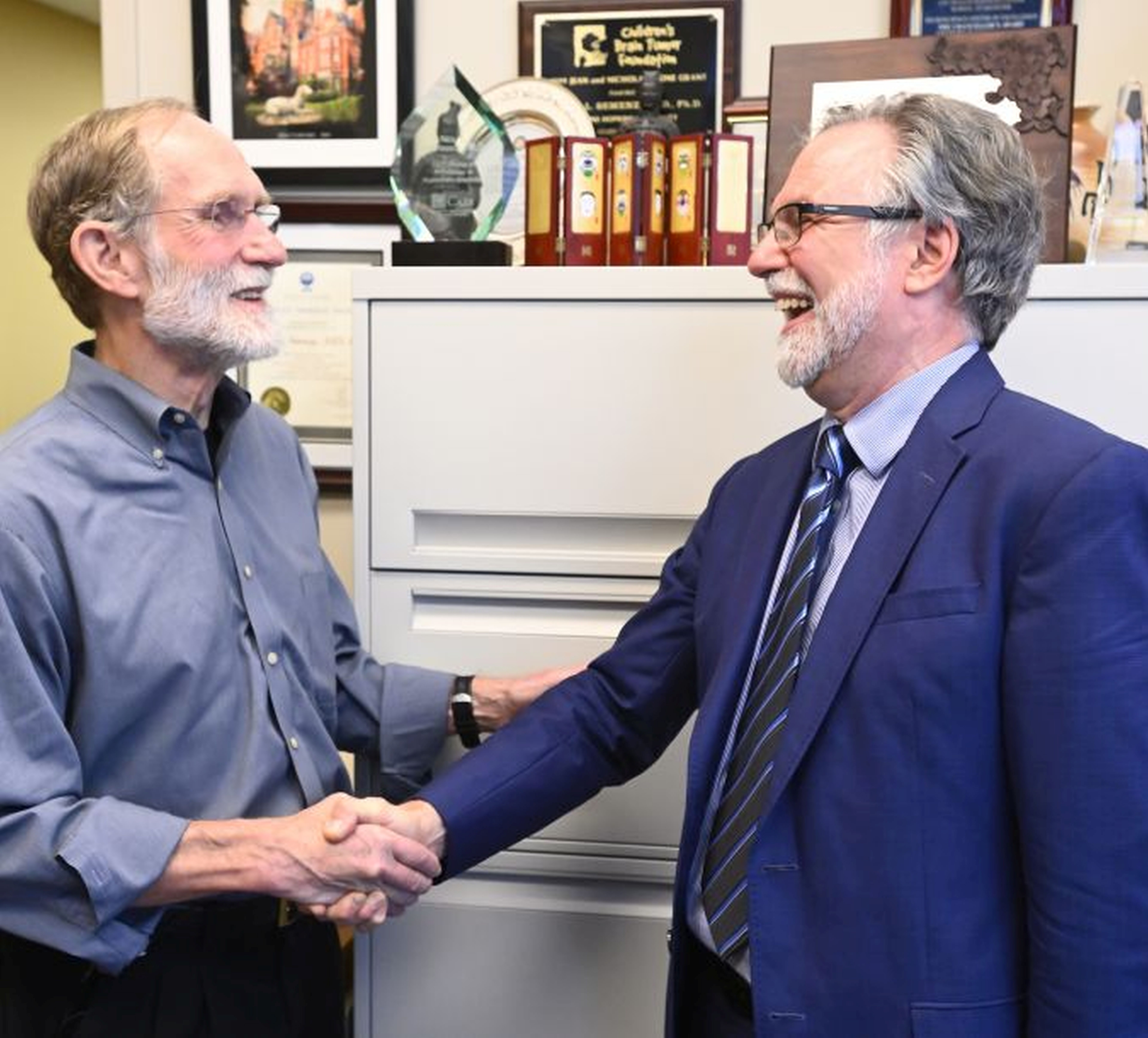 Nobel Laureate Peter Agre, left, congratulates Gregg Semenza on winning the 2019 Nobel Prize in Physiology or Medicine.