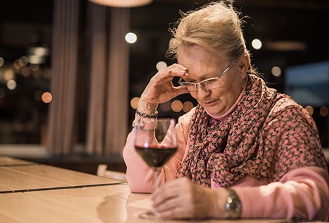  A photo shows a woman with a glass of wine.