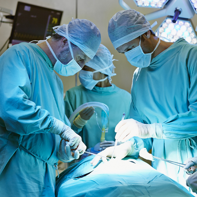 A photo shows clinicians in an operating room.