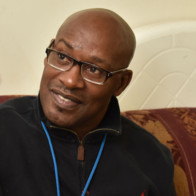Community health worker William Glover-Bey speaks to pa-tient Rosalyn Jordan during a visit to her Northeast Balti-more apartment.