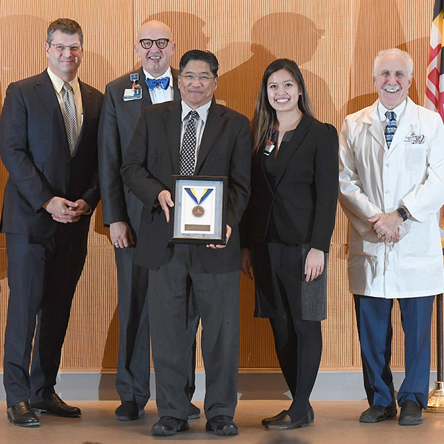 Left to right: Jonathan Efron, senior vice president for the Office of Johns Hopkins Physicians; Kevin W. Sowers, president of Johns Hopkins Health System and executive vice president of Johns Hopkins Medicine; physician Norman Dy and nurse practitioner Carolyn Le with the Direct Primary Care team; and Paul B. Rothman, dean of the medical faculty and CEO of Johns Hopkins Medicine.