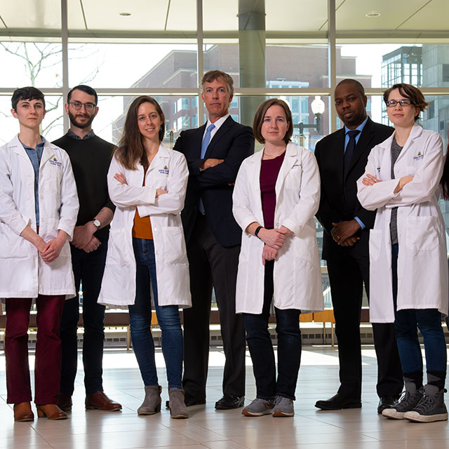 Photo of six graduate students plus two members of the faculty and one of leadership, all working together to combat learner mistreatment.