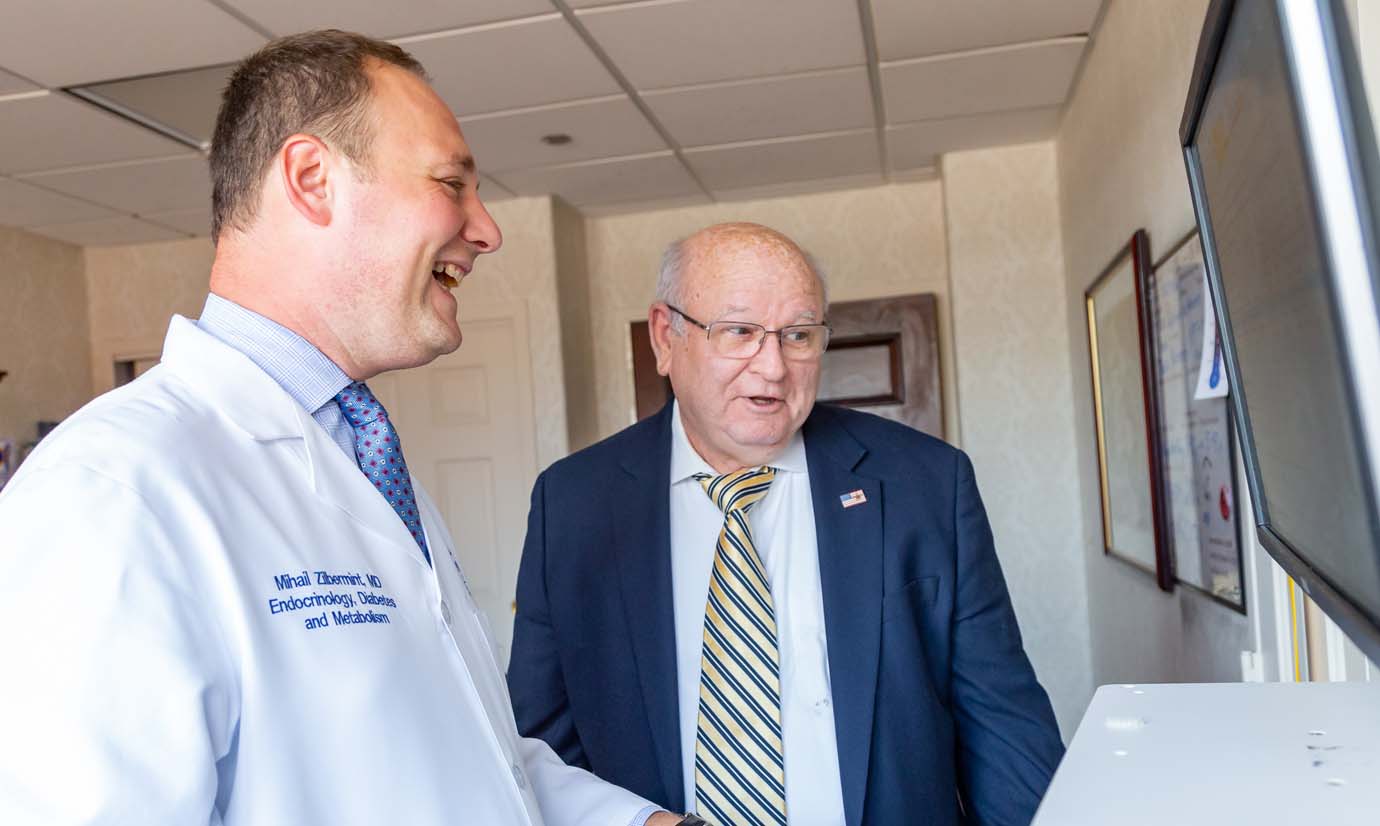 Reviewing his electronic medical history at a standing computer work station, Ralph Roarty discusses his history of diabetes with Mihail Zilbermint, M.D., chief of endocrinology, diabetes and metabolism at Suburban Hospital and director of the hospital’s Inpatient Diabetes Management Service.