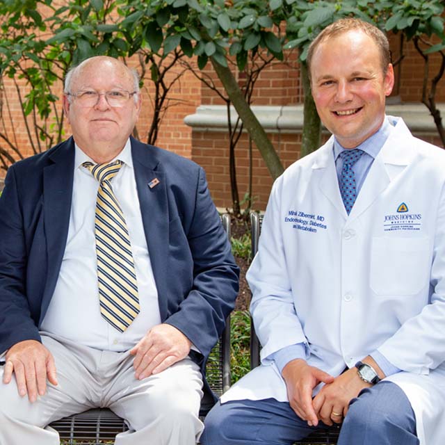On a recent sunny summer day, XXXXXXX, Mihail Zilbermint. M.D., and Ralph Roarty chat on a bench outside Suburban Hospital.