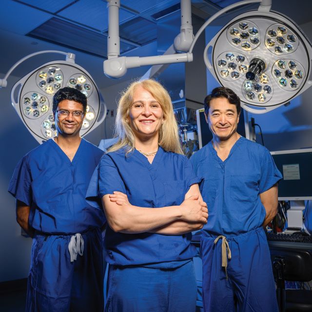 Pradeep Ramulu, Esen Akpek and Jim Handa standing in an operating room in Wilmer’s Bendann Surgical Pavilion.