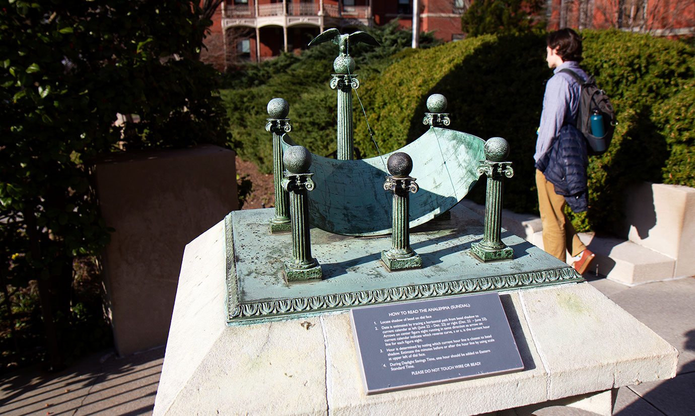 A photo of the full sundial sitting on a stone base