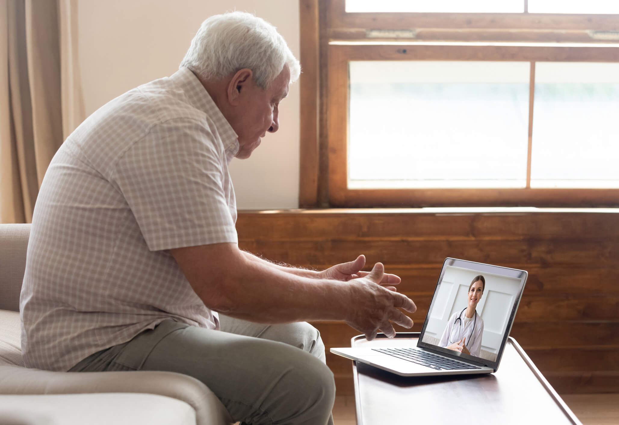 man connects with a doctor during a telemedicine appointment