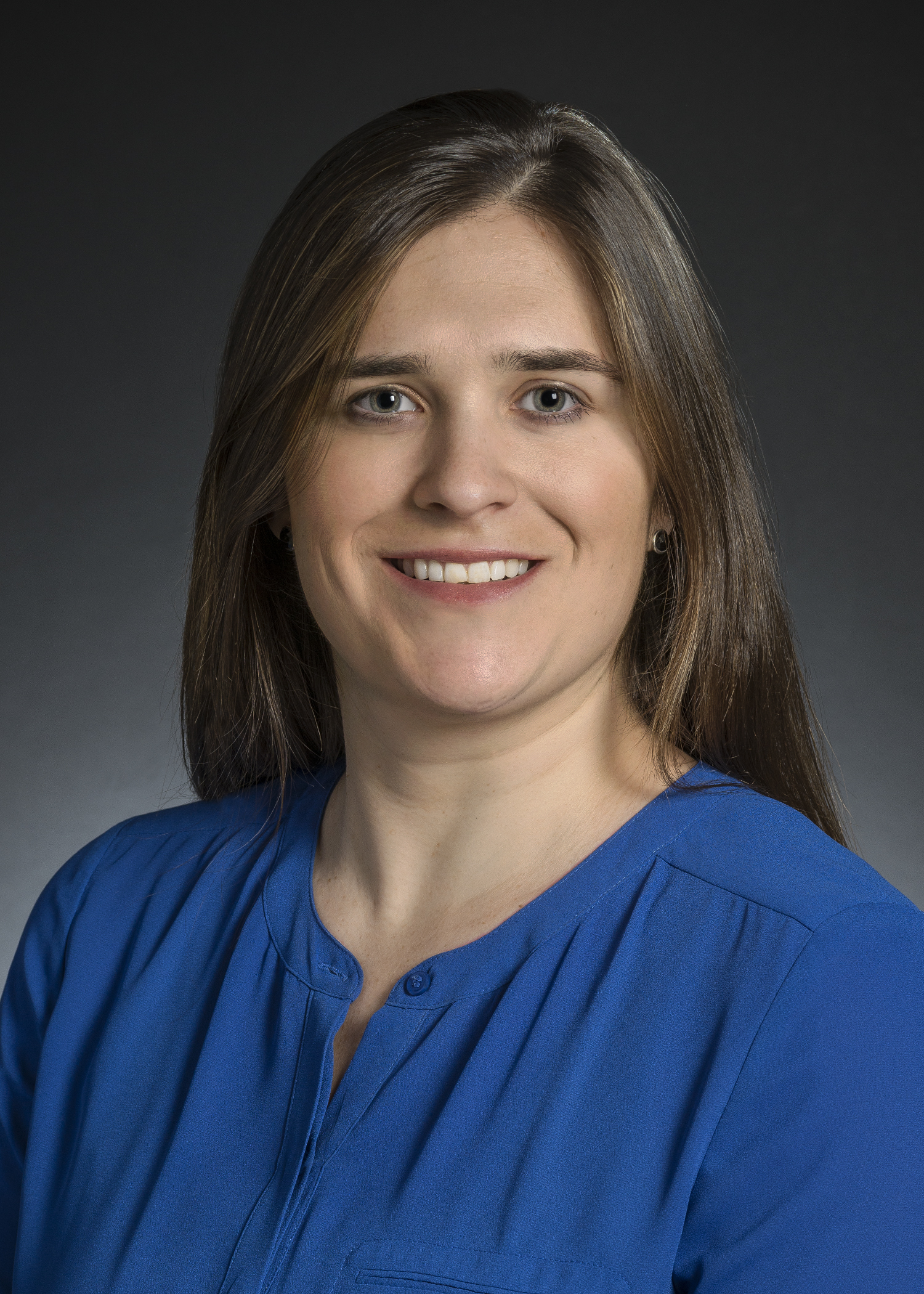 Formal portait of Caitlin Hicks in blue top