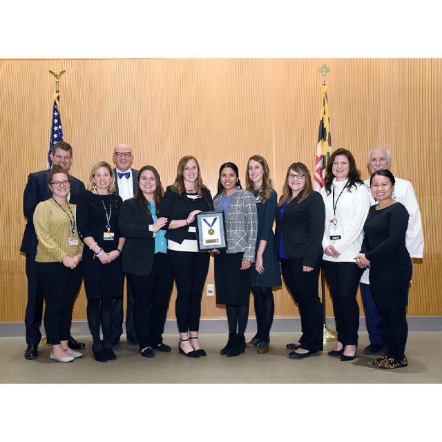 Group photo shows the Heart Failure Bridge Clinic team accepting a clinical innovation award from Dean/CEO Paul Rothman in 2019.