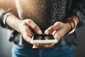 a woman uses her phone to research coronavirus myths and misinformation