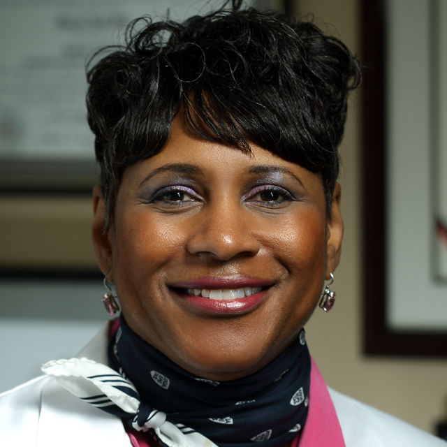 head shot of Dr. Golden in a bright scarf and white coat