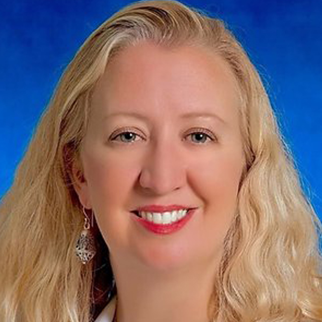 head shot of Nicole Shilkofski against a blue background